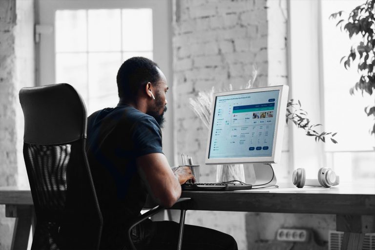 man using computer looking at visual flight shopping