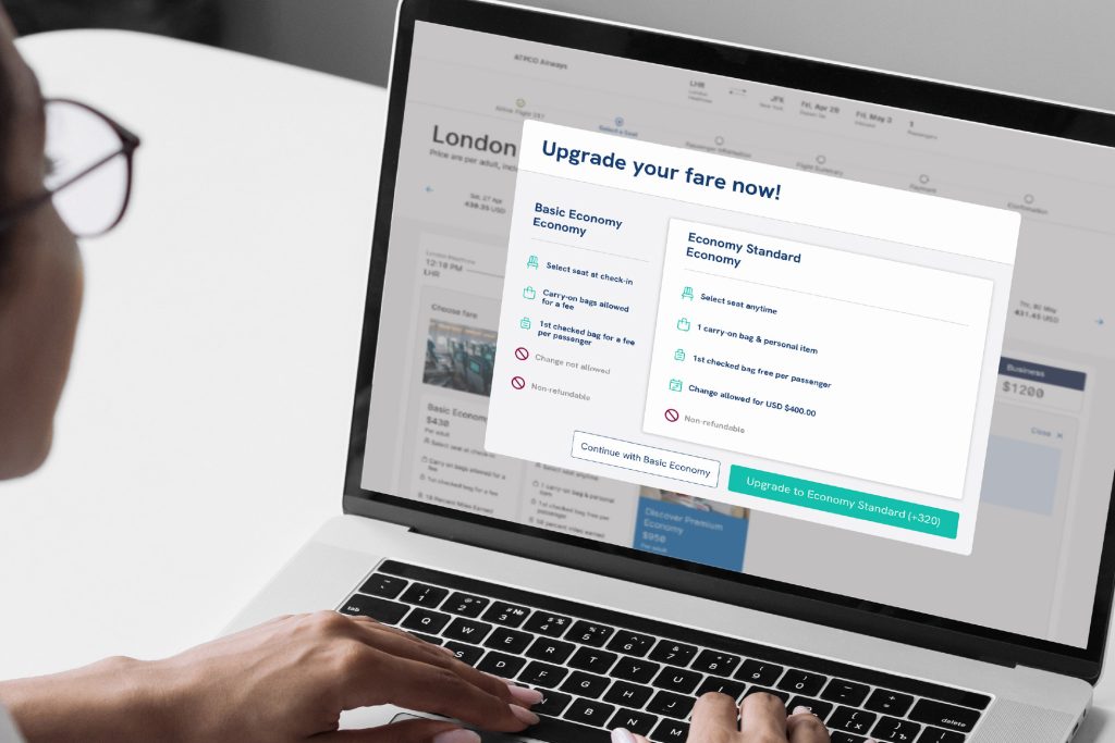 flight shopper looking at upgrading fares on computer