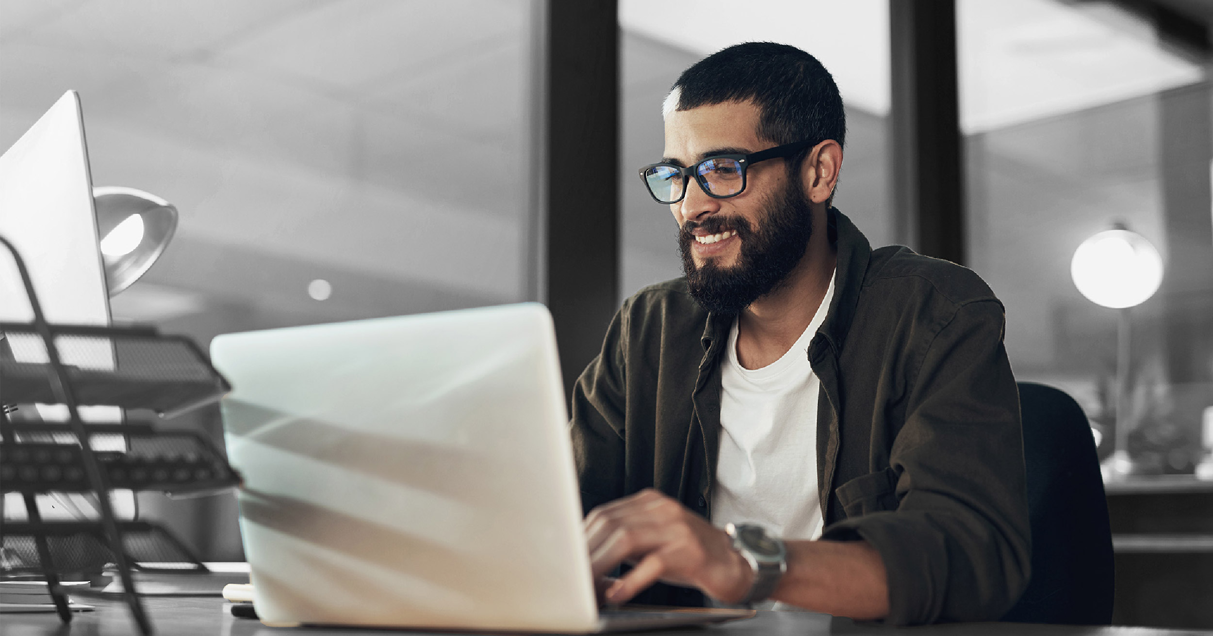 Man smiling at computer - pros case study